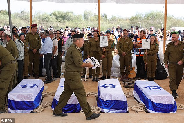 The BBC has faced furious criticism over its refusal to describe the Hamas killing of around 1,300 Israelis, many of them civilians, as terrorism. Pictured: Israeli soldiers place the coffins of five family members of the Kutz family during their funeral in Gan Yavne, Israel