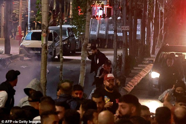 Protesters and Palestinian security forces clash during a rally in Ramallah on Tuesday night