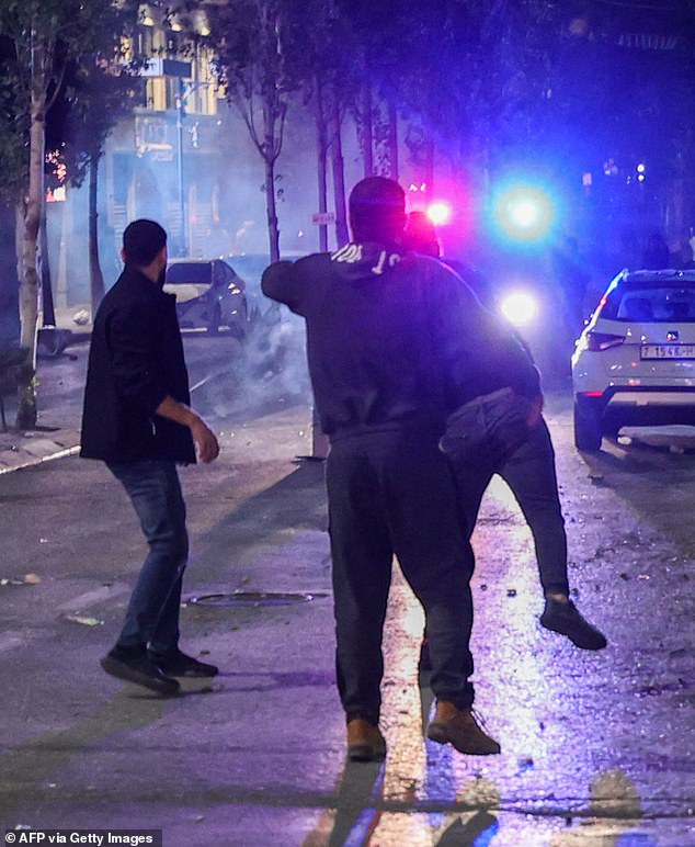 Protesters are pictured following a clash with security forces at a rally in solidarity with the Palestinians of the Gaza Strip in the West Bank city of Ramallah