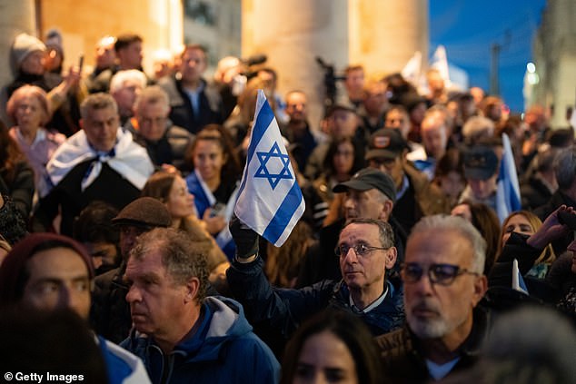 One protester stood on the railings next to the BBC building and led chants using a megaphone as people in the crowd waved Israeli flags