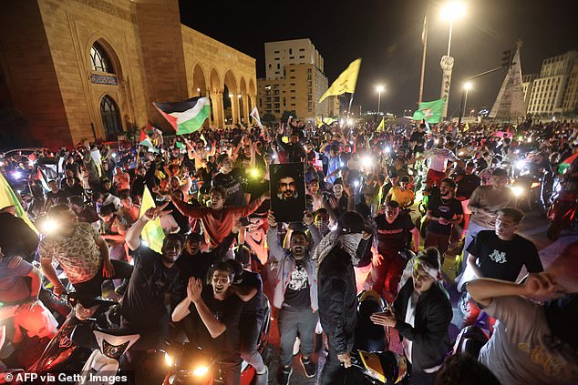 Lebanese protesters wave Palestinian national flags and shout slogans in solidarity with the people of Gaza in down town Beirut, after a strike on a hospital in the Gaza Strip