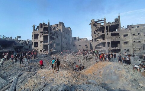 Palestinians search for casualties at the site of Israeli strikes on houses in Jabalia refugee camp in northern Gaza