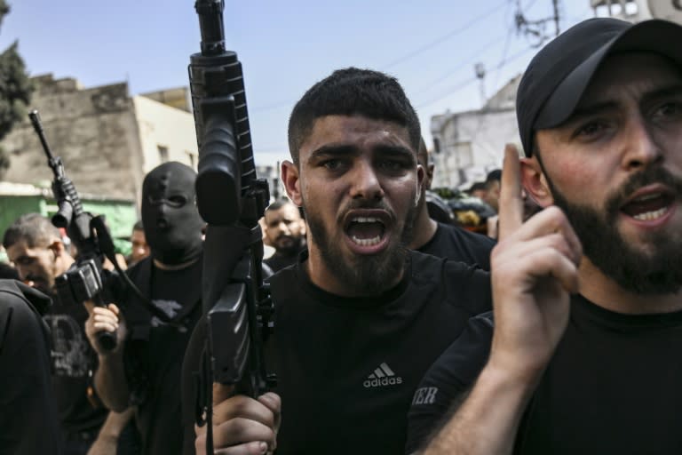 Armed Palestinians join the funeral procession for three militants killed in an overnight raid by the Israeli army on Jenin refugee camp in the occupied West Bank (Aris MESSINIS)