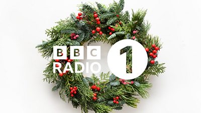 The BBC Radio 1 logo appears in white over an image of a green Christmas wreath with red berries.