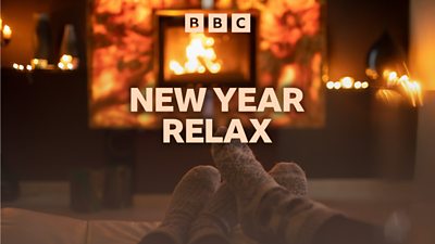 Artwork for BBC Sounds' New Year Relax featuring a cosy living room with a fireplace. Two pairs of feet in warm socks point towards the fire. 