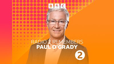 Artwork for Radio 2 Remembers Paul O'Grady, featuring a photo of Paul O'Grady against an orange and red background. 