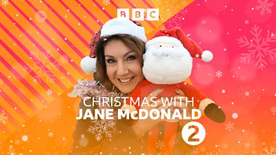 Jane McDonald smiles to camera, wearing a Santa hat and holding a cuddly toy Santa. Text on the image reads: 