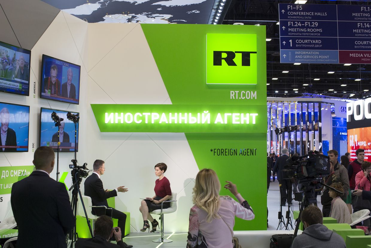 A television broadcaster interviews a guest on the set of RT.com at the St. Petersburg International Economic Forum (SPIEF) in St. Petersburg, Russia, on May 25, 2018. 