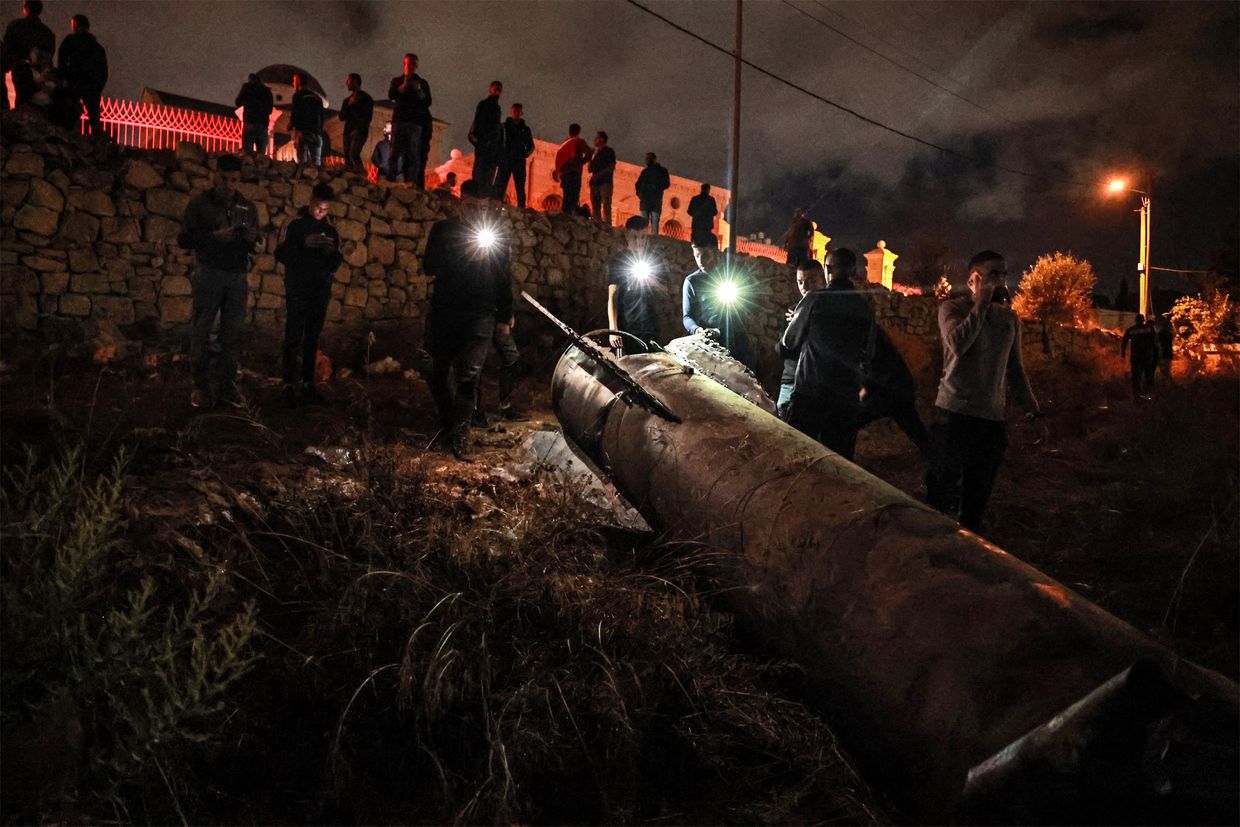 Palestinian youths inspect a fallen projectile after Iran launched a barrage of missiles at Israel in Ramallah in the occupied West Bank on Oct.
/p
p1, 2024.